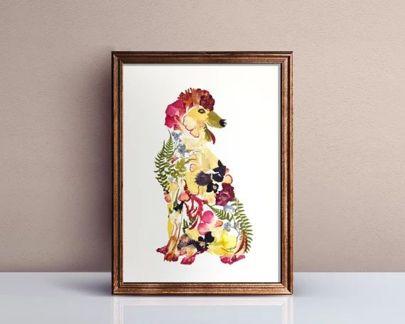 A dog portrait made from pressed petals in a timber frame